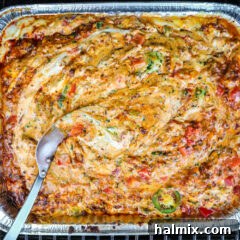 smoked queso dip in a foil pan