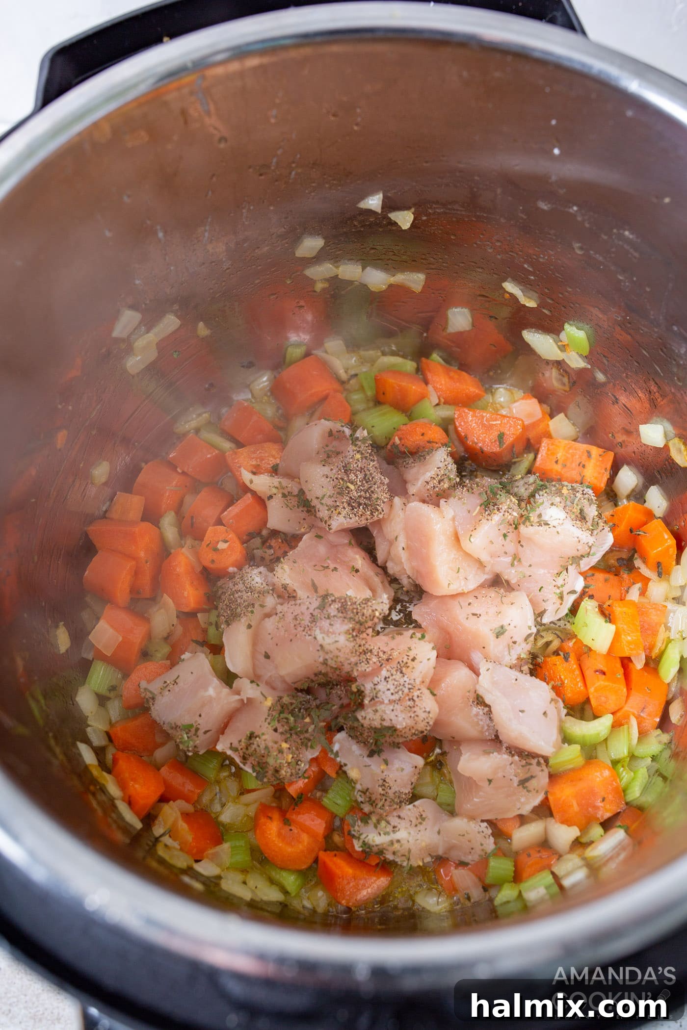Easy Instant Pot Chicken and Rice 5 Searing chicken breast with carrots, celery, and seasonings in an Instant Pot to develop deep flavors.