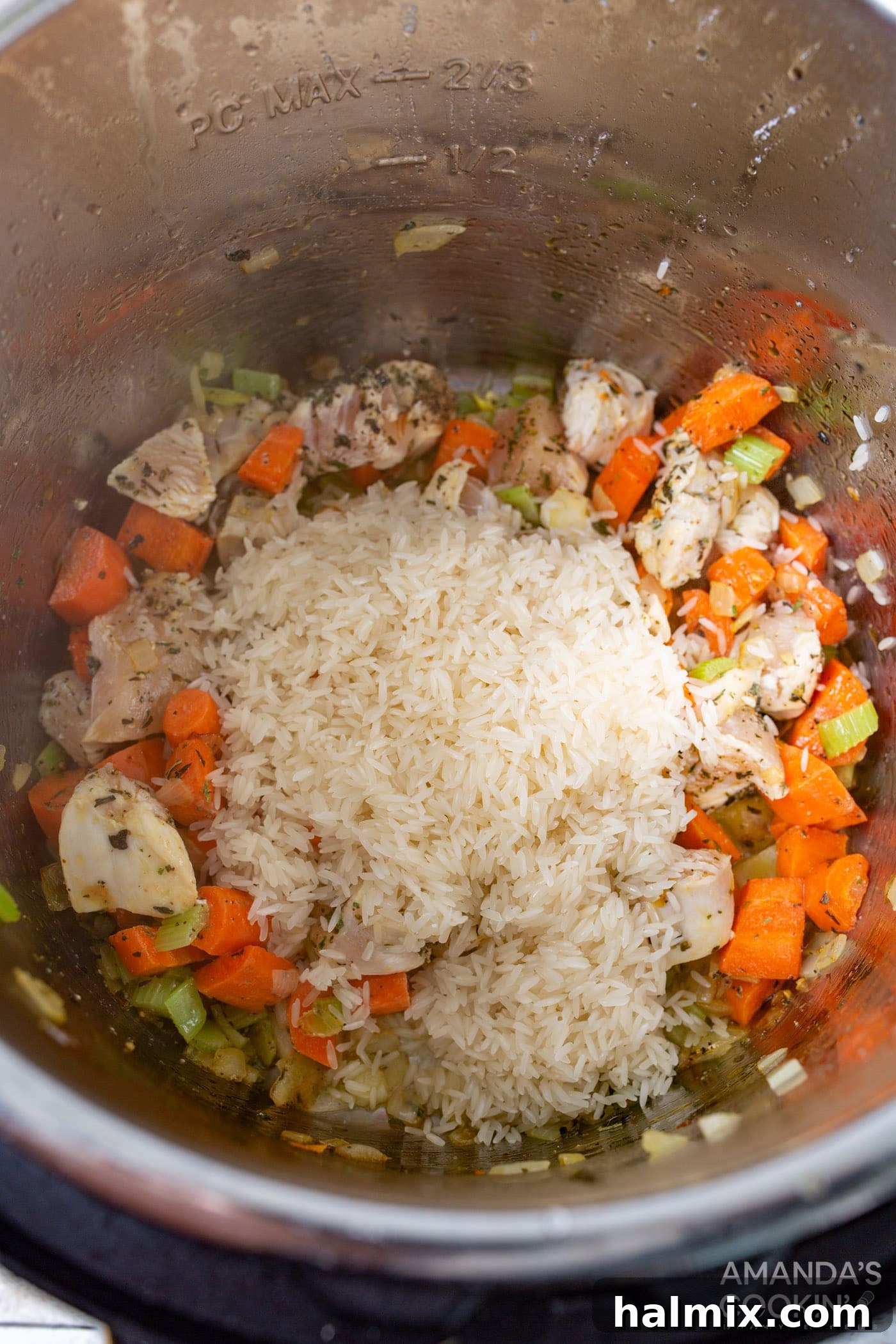 Easy Instant Pot Chicken and Rice 6 Rinsed rice, chicken, and vegetables being mixed gently in the Instant Pot before adding liquid.