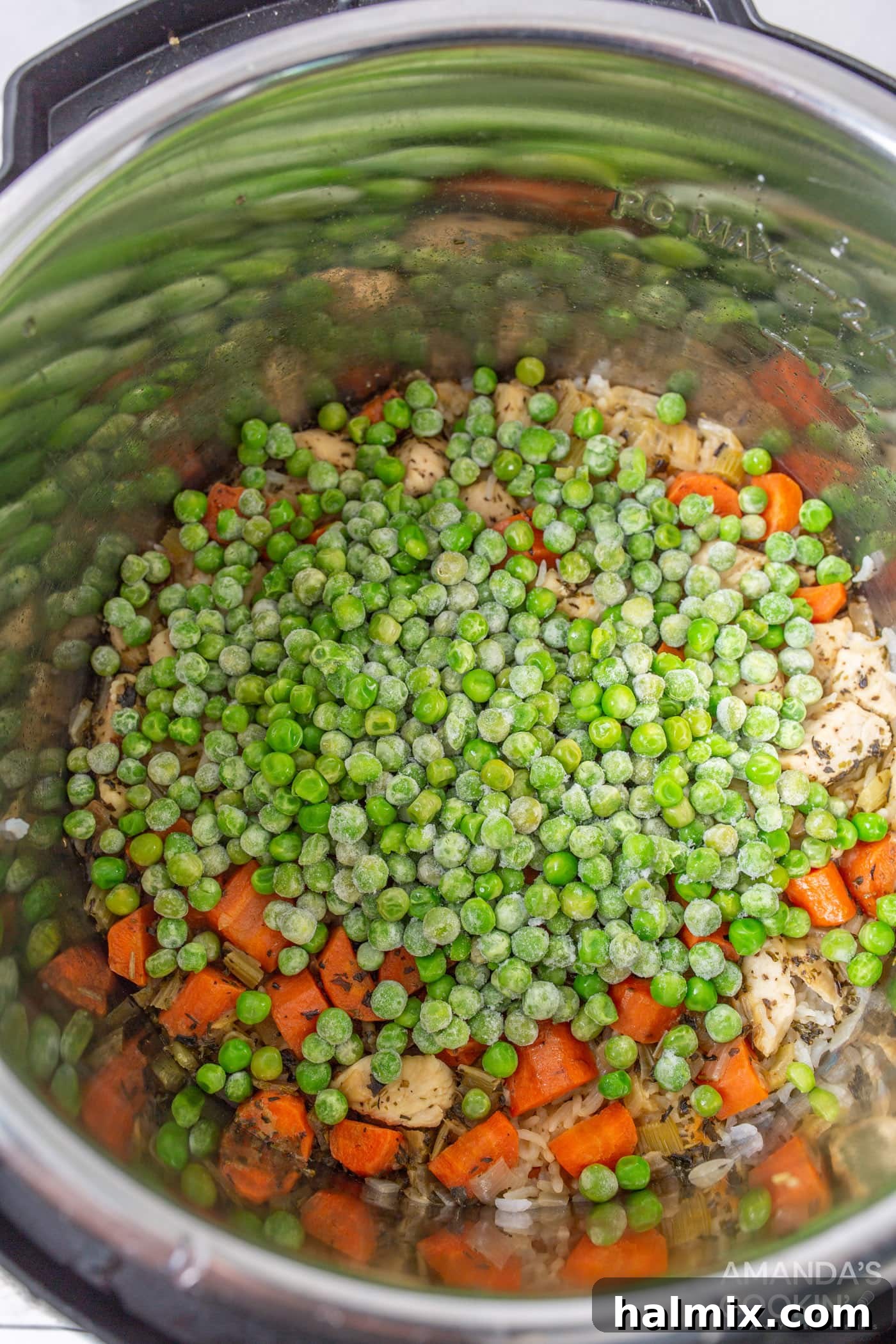 Easy Instant Pot Chicken and Rice 8 Adding vibrant frozen peas to the hot chicken and rice in the Instant Pot, stirring to combine.