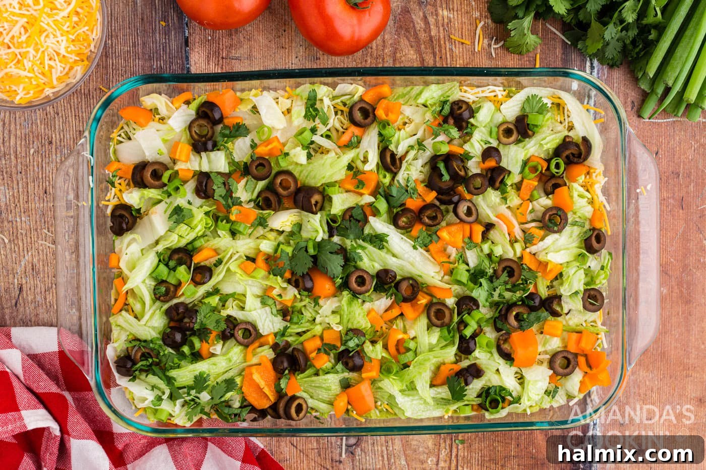 Variety of fresh vegetables layered on top of the taco dip.