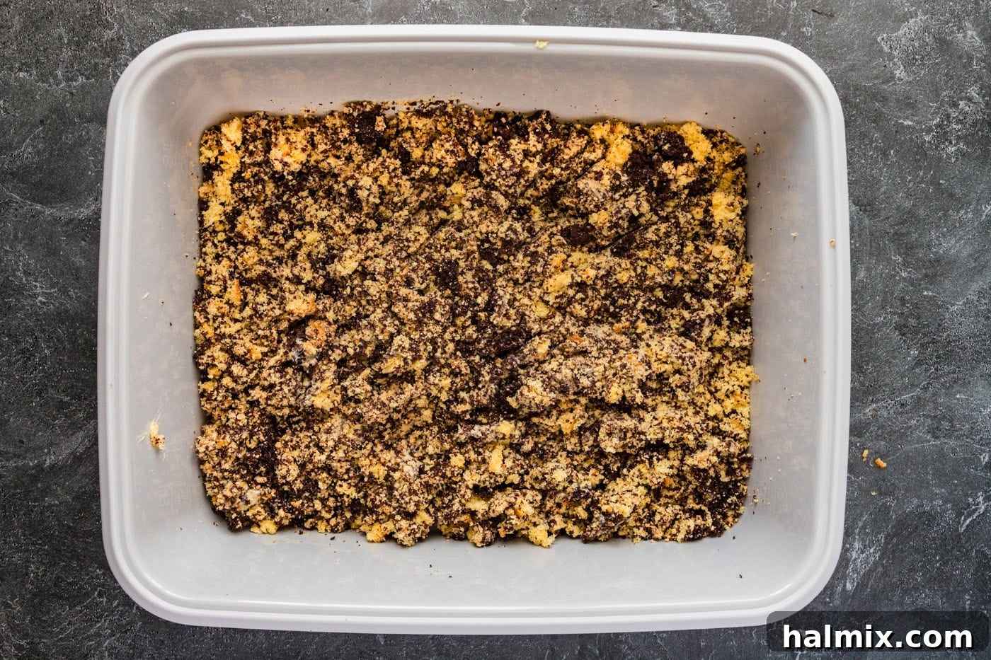 The cake, crushed cookies, and pudding mixed together in a cat litter pan, forming the base of the Kitty Litter Cake.