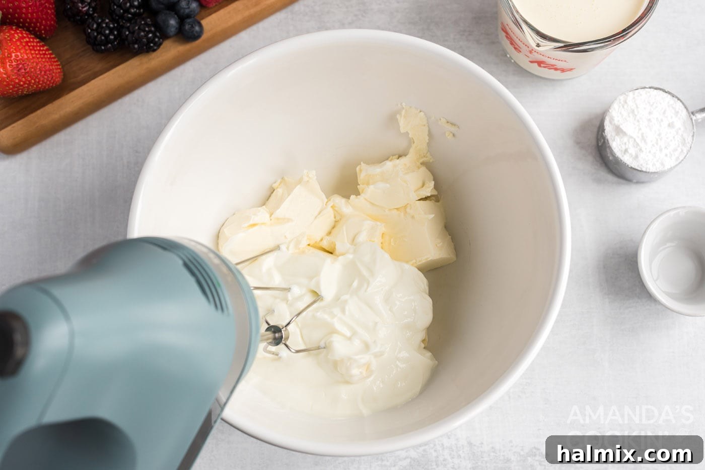 Crimson Crust Pizza 5 cream cheese and greek yogurt being beaten with a hand mixer