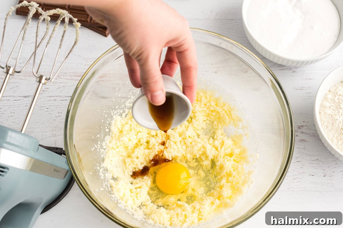 Gooey S'mores Bars 6 adding vanilla to eggs in bowl