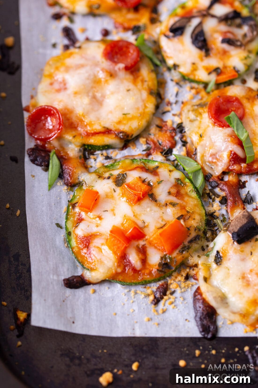 Zucchini Pizza Bites on parchment paper, ready to be served