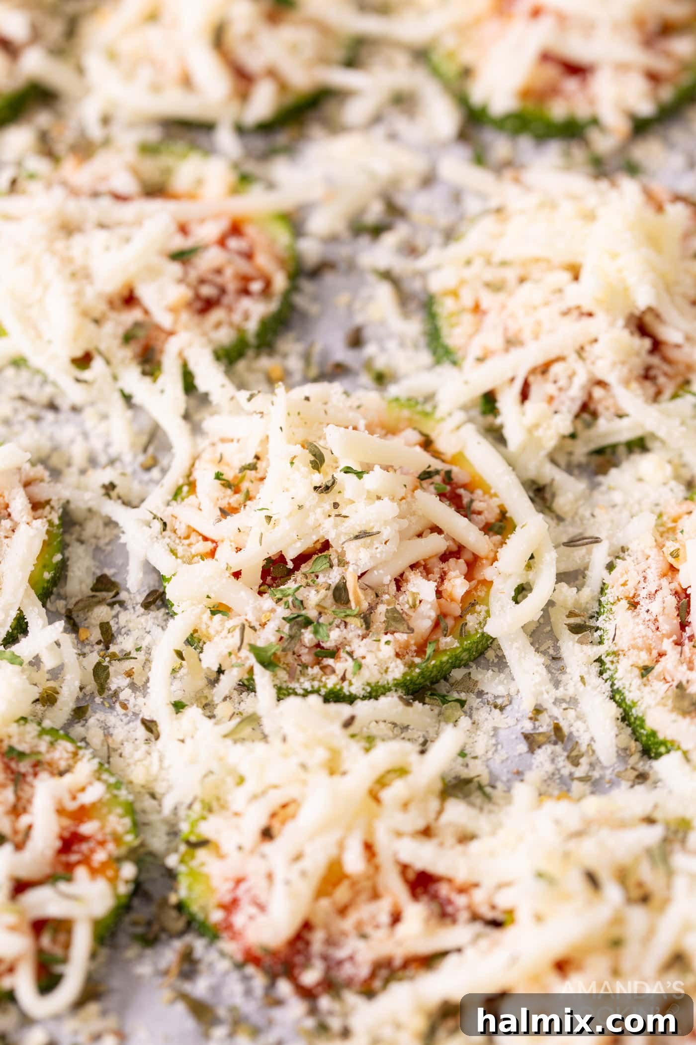Cheese and Italian seasonings generously sprinkled on zucchini slices