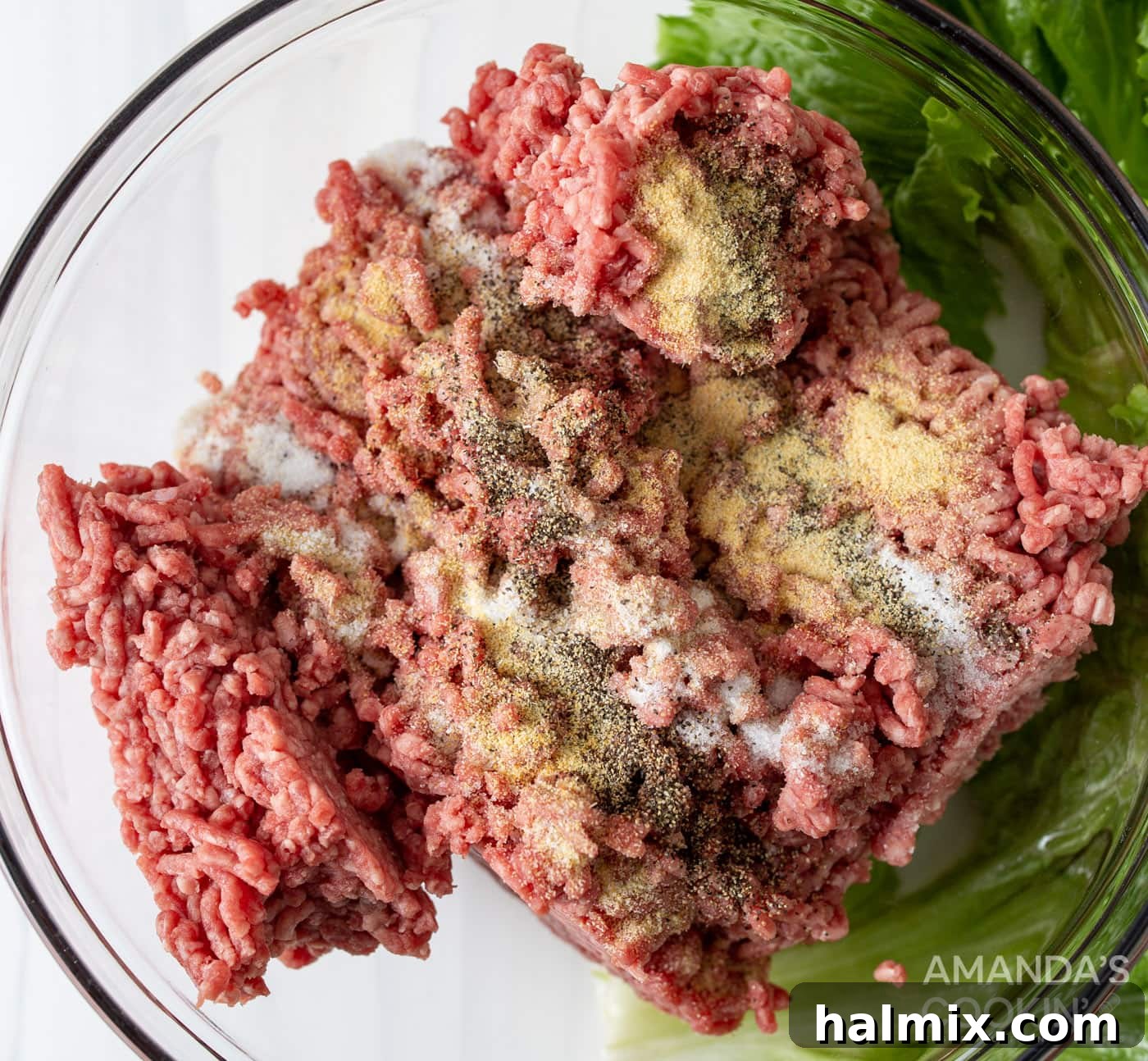 Bacon Cheeseburger Bombs 5 Ground beef and seasonings perfectly combined in a mixing bowl, ready to be formed into meatballs.