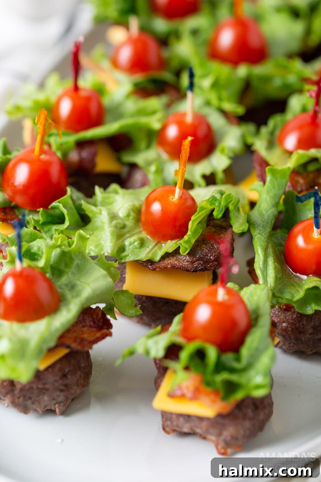 Bacon Cheeseburger Bombs 10 A beautifully arranged platter of Bacon Cheeseburger Meatball appetizers, garnished and ready for guests to enjoy.