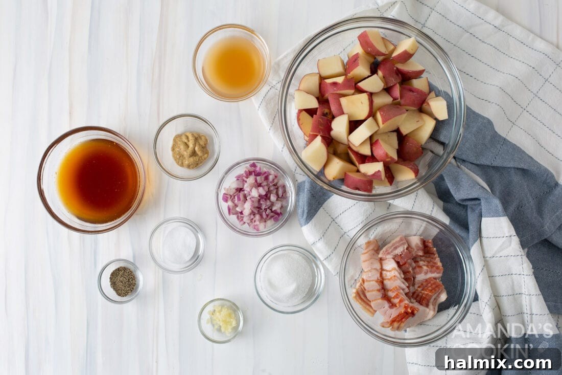 Tangy Bacon Potato Salad 4 Fresh ingredients laid out for German Potato Salad preparation, including red potatoes, red onions, bacon, garlic, apple cider vinegar, Dijon mustard, and beef broth.