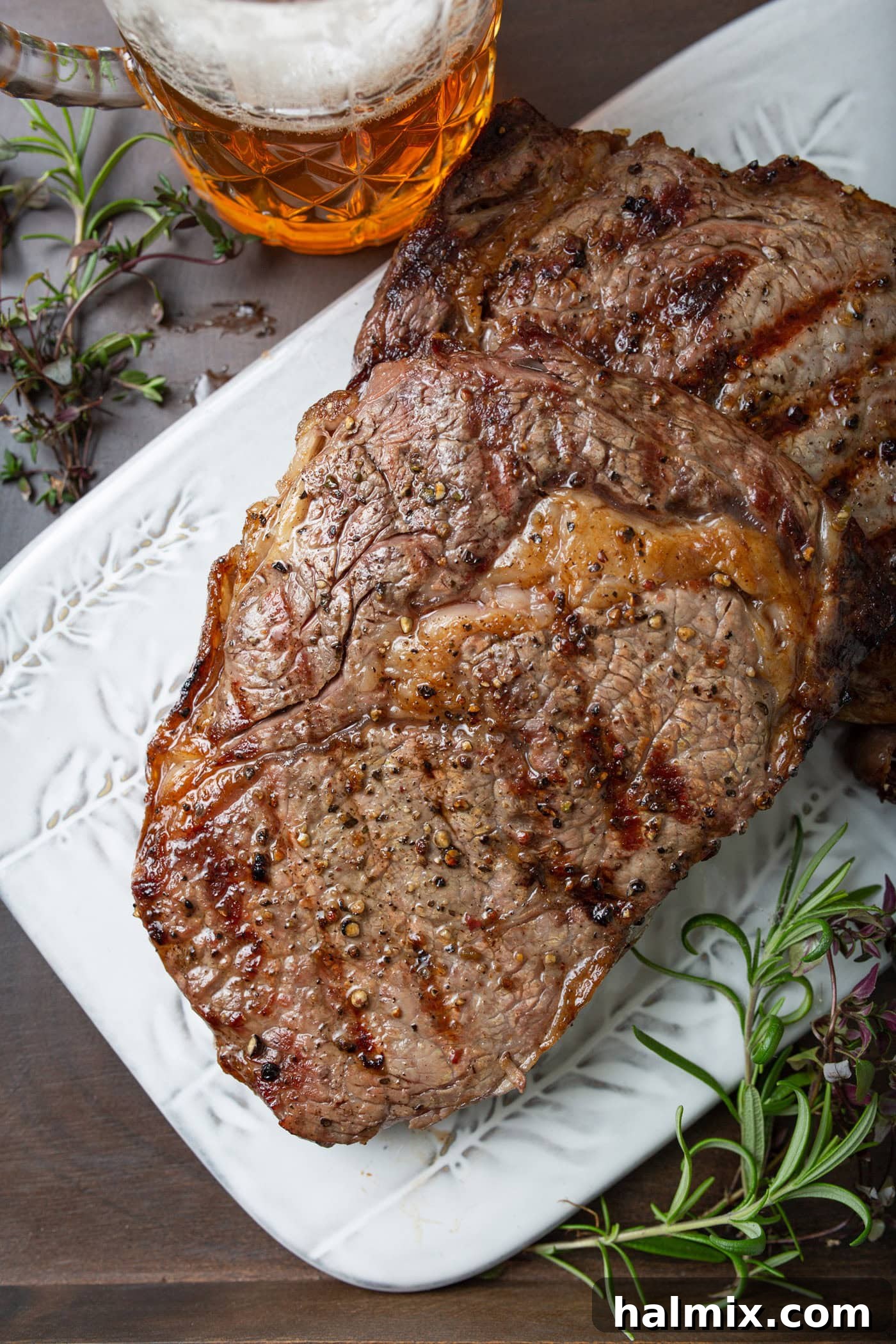 A perfectly grilled steak resting on a clean plate, allowing its delicious juices to redistribute for ultimate tenderness