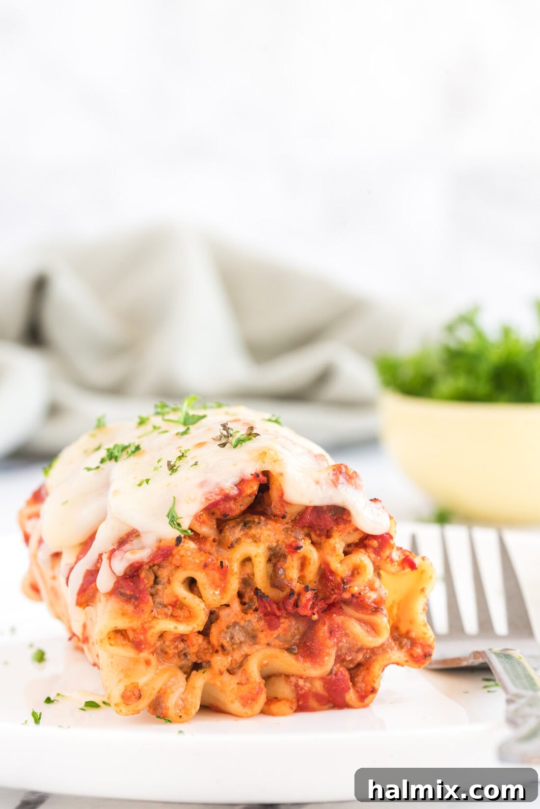 Savory Lasagna Spirals 5 Lasagna Roll Up with a fork on a plate