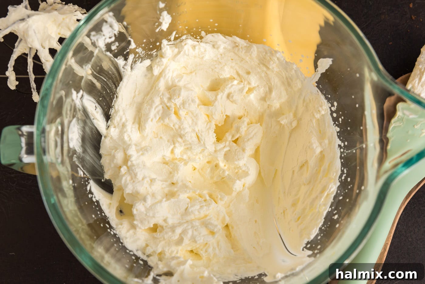Heavy whipping cream in a mixer bowl, perfectly beaten to stiff peaks, ready to be folded into the mascarpone mixture.