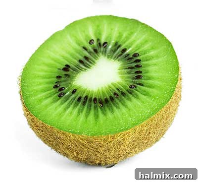 Sliced kiwi fruit showing vibrant green flesh and tiny black seeds.