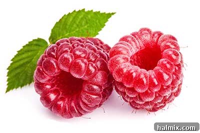A close-up shot of fresh, vibrant red raspberries.