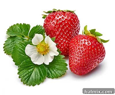 A pile of fresh, vibrant red strawberries with green stems.