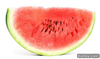 A slice of vibrant red watermelon with black seeds.