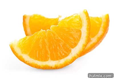 Bright, fresh oranges, some whole and some sliced.