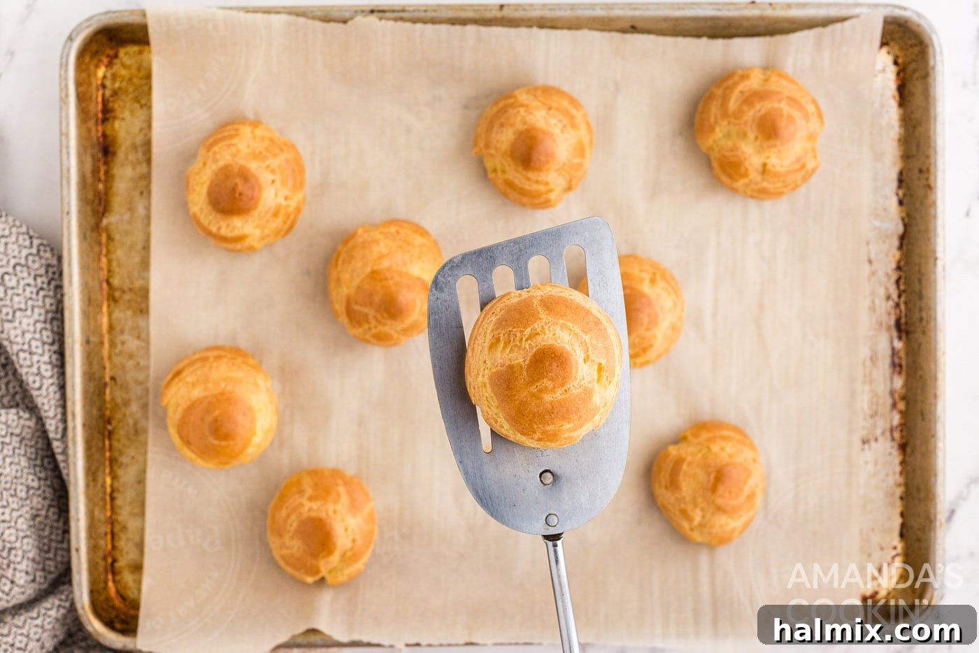 Puffy Cream Delights 10 golden brown choux pastry on spatula