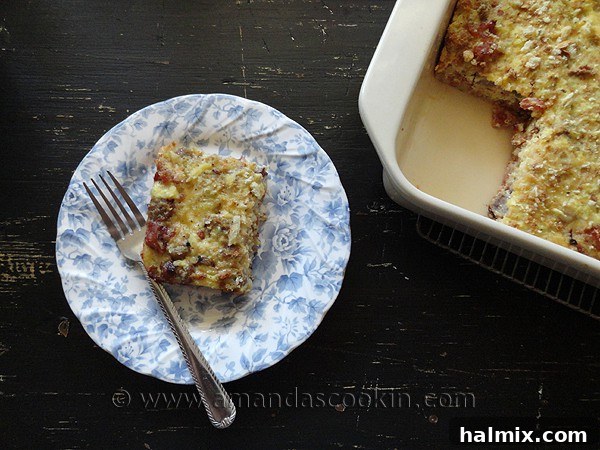 An overhead photo of a serving of herbed breakfast stuffing casserole on a white and blue plate, ready to be enjoyed.