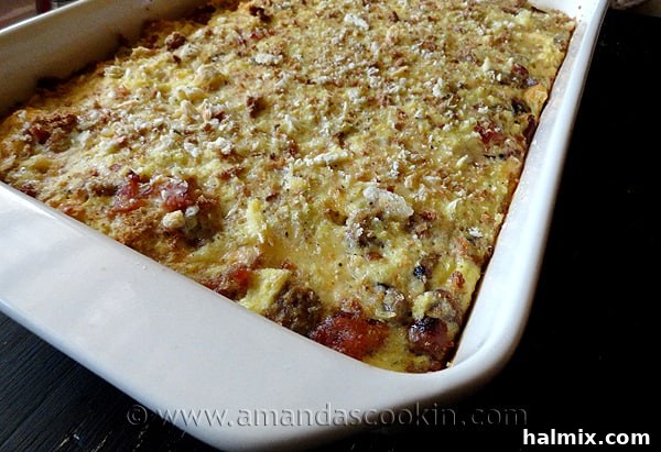 A close-up photo of a herbed breakfast stuffing casserole, showing its enticing layers of ingredients.