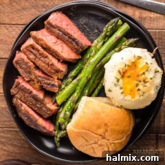 Smoked Ribeye with potatoes and asparagus as side dishes.