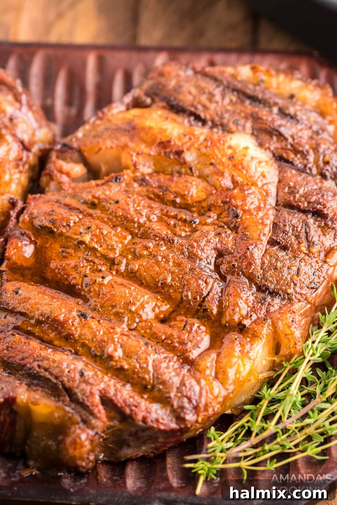 Close-up view of a perfectly cooked smoked ribeye steak, showing its juicy interior and crispy crust.