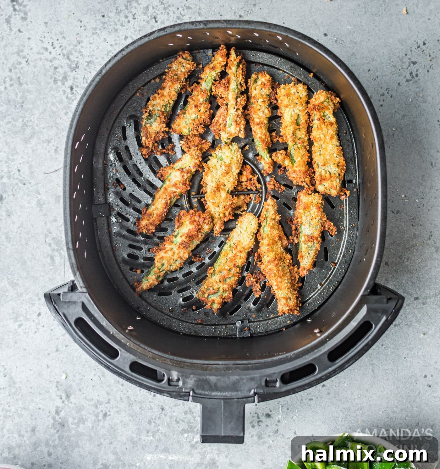 Perfectly golden brown and crispy jalapeno fries inside the air fryer basket