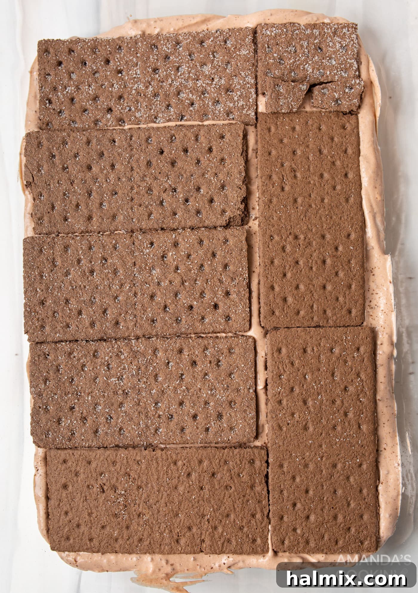 graham crackers on top of chocolate pudding mix in baking dish