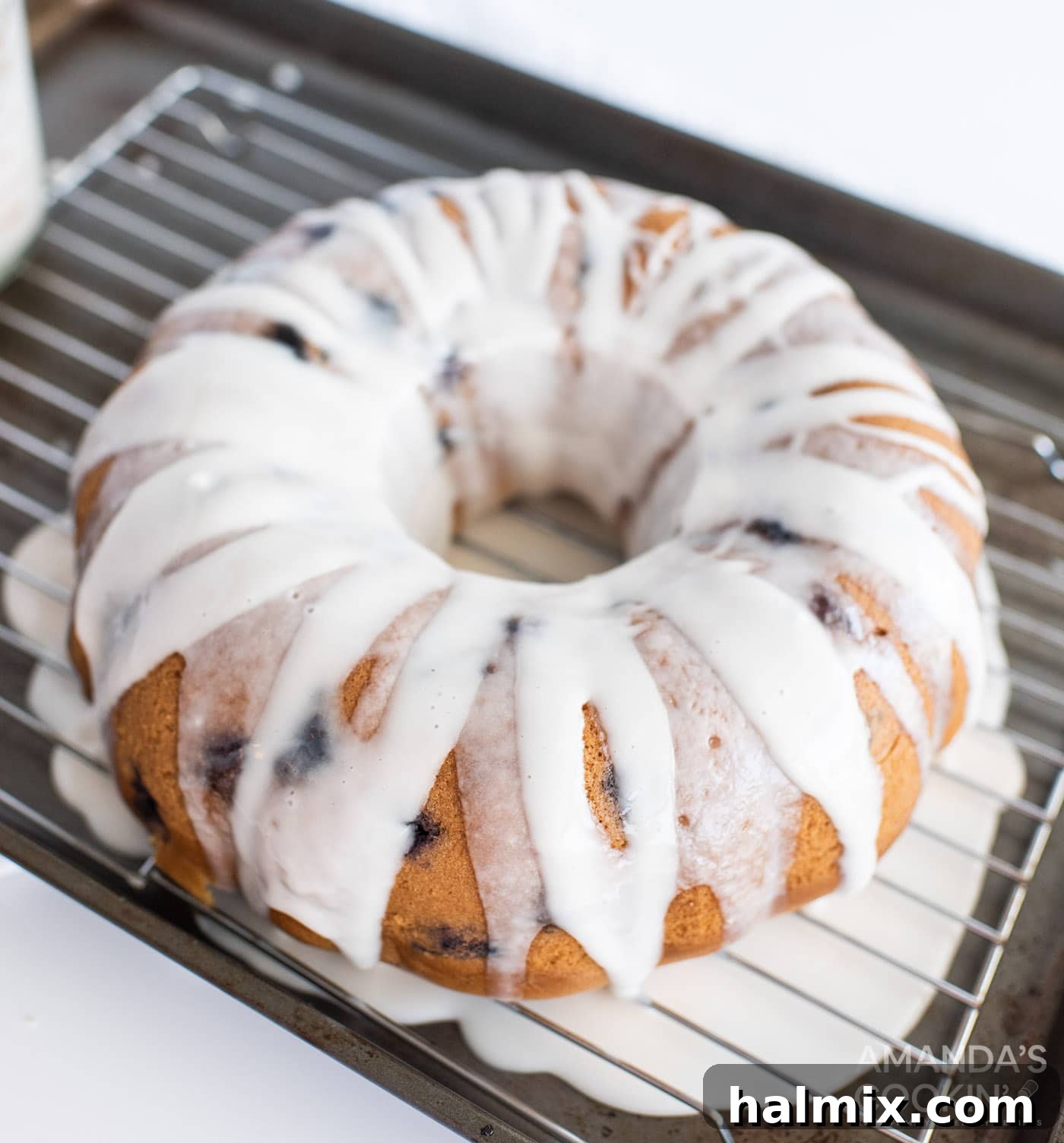 freshly glazed blueberry bundt cake adorned with extra blueberries, ready to be served