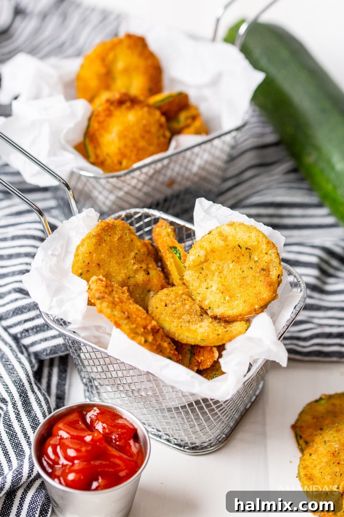 A basket brimming with golden brown fried zucchini rounds