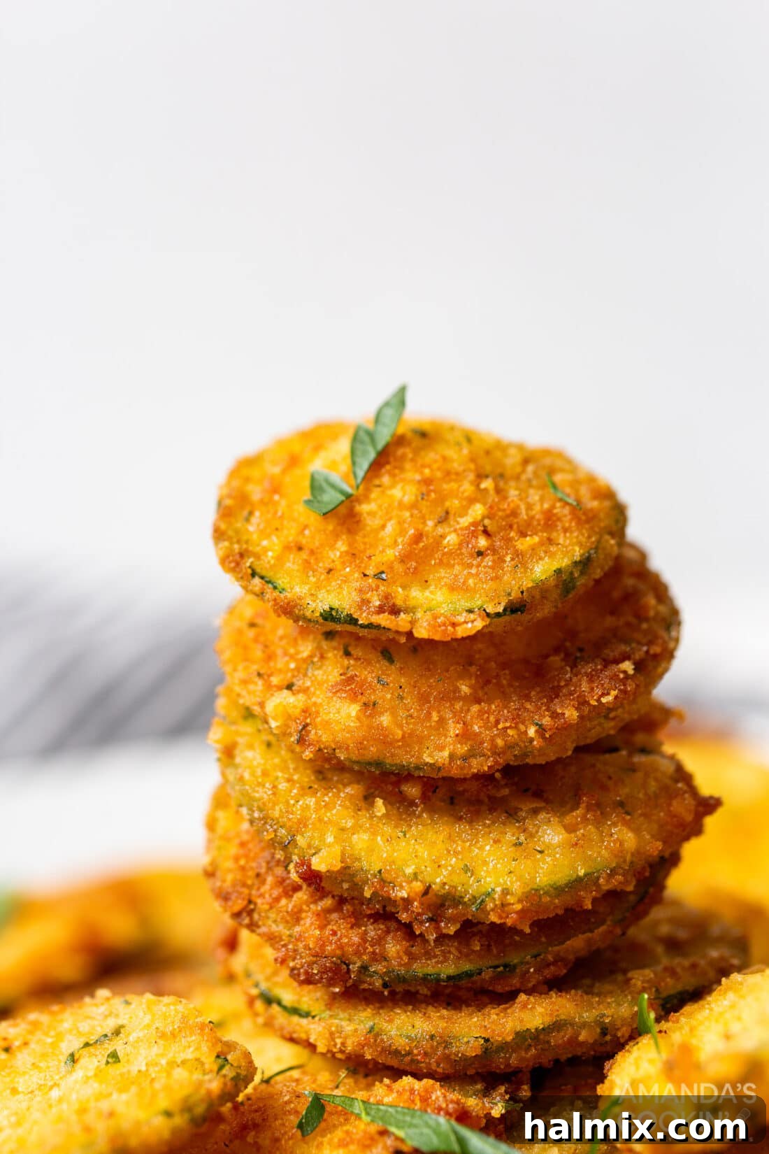 A beautifully stacked serving of golden fried zucchini