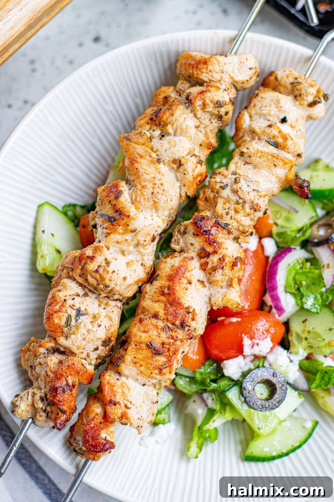 Zesty Mediterranean Chicken Skewers 3 Greek Chicken Kabobs on a plate with salad