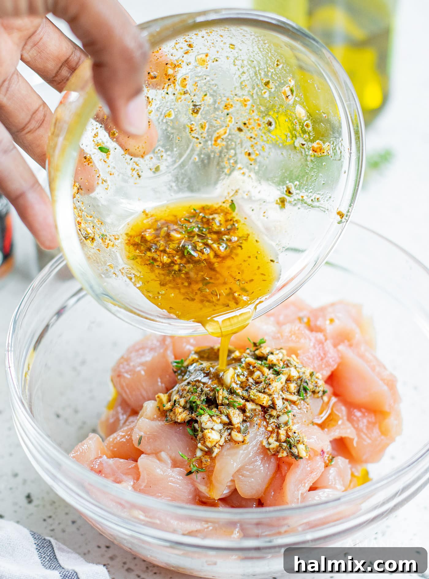 Zesty Mediterranean Chicken Skewers 6 pouring marinade on chicken