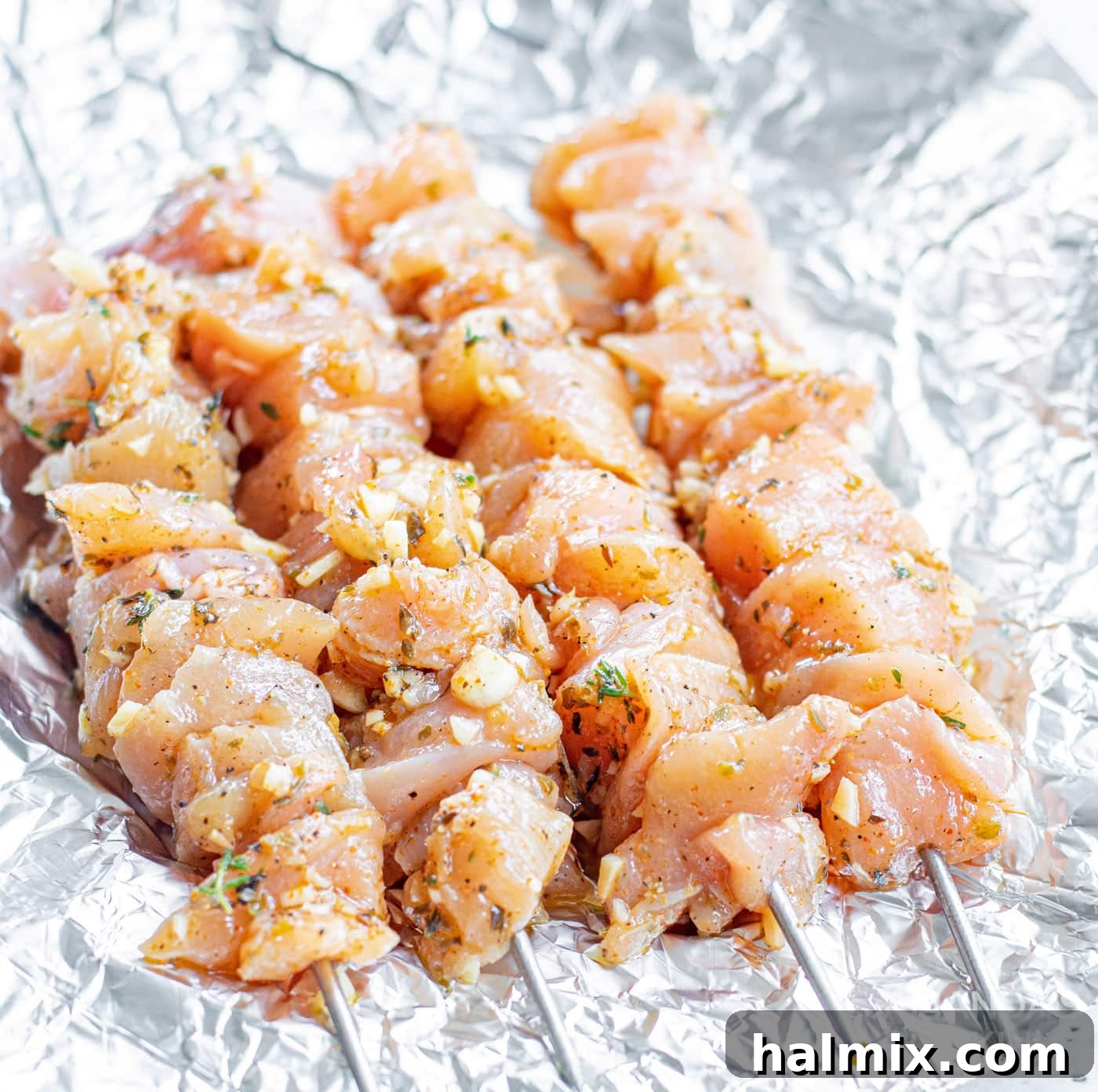 Zesty Mediterranean Chicken Skewers 7 chicken skewers on tin foil