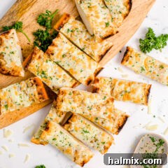 Sliced Cheesy Garlic Bread on a cutting board, ready for serving