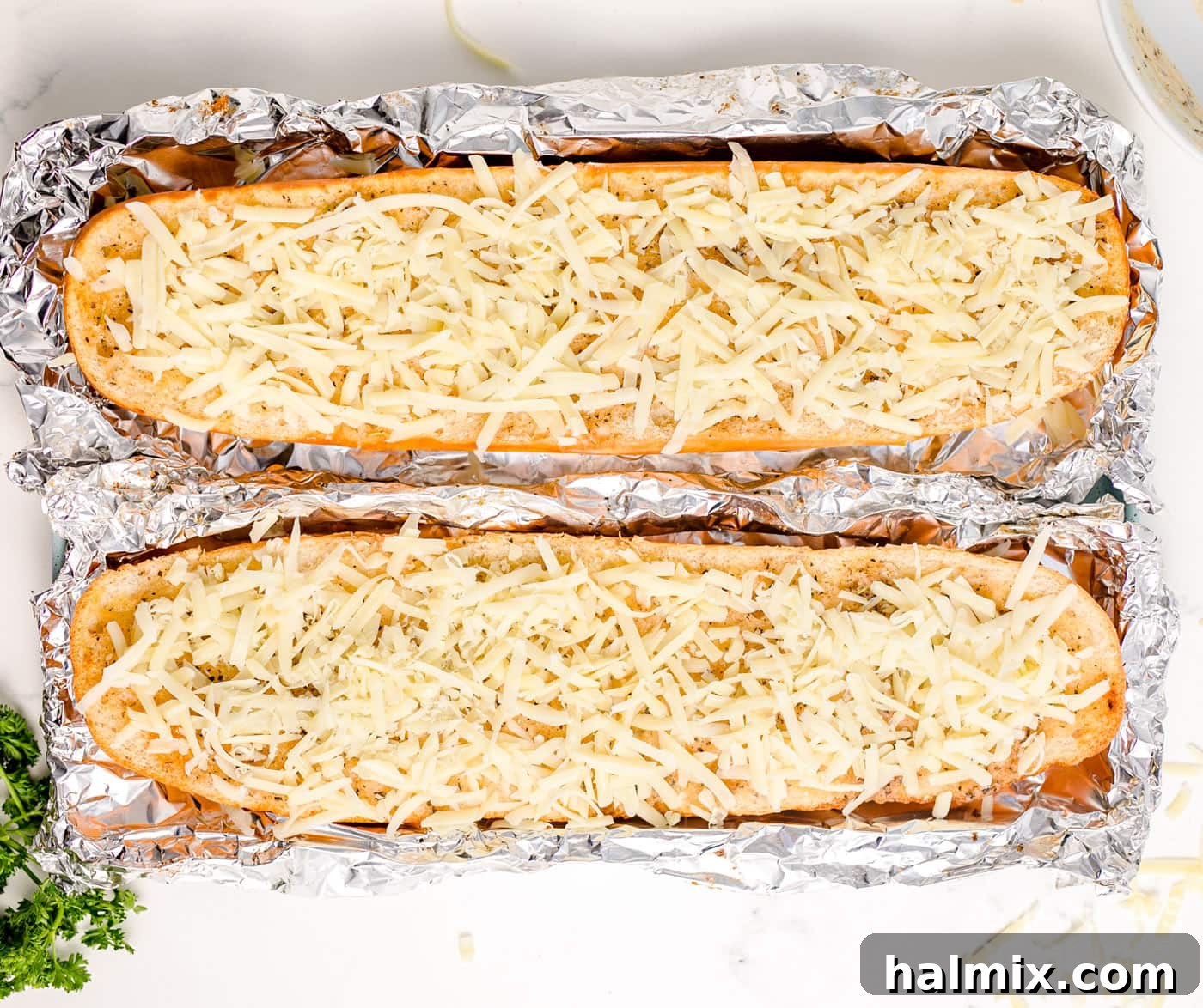 Cheesy garlic bread on a pan with melted mozzarella cheese, fresh out of the oven