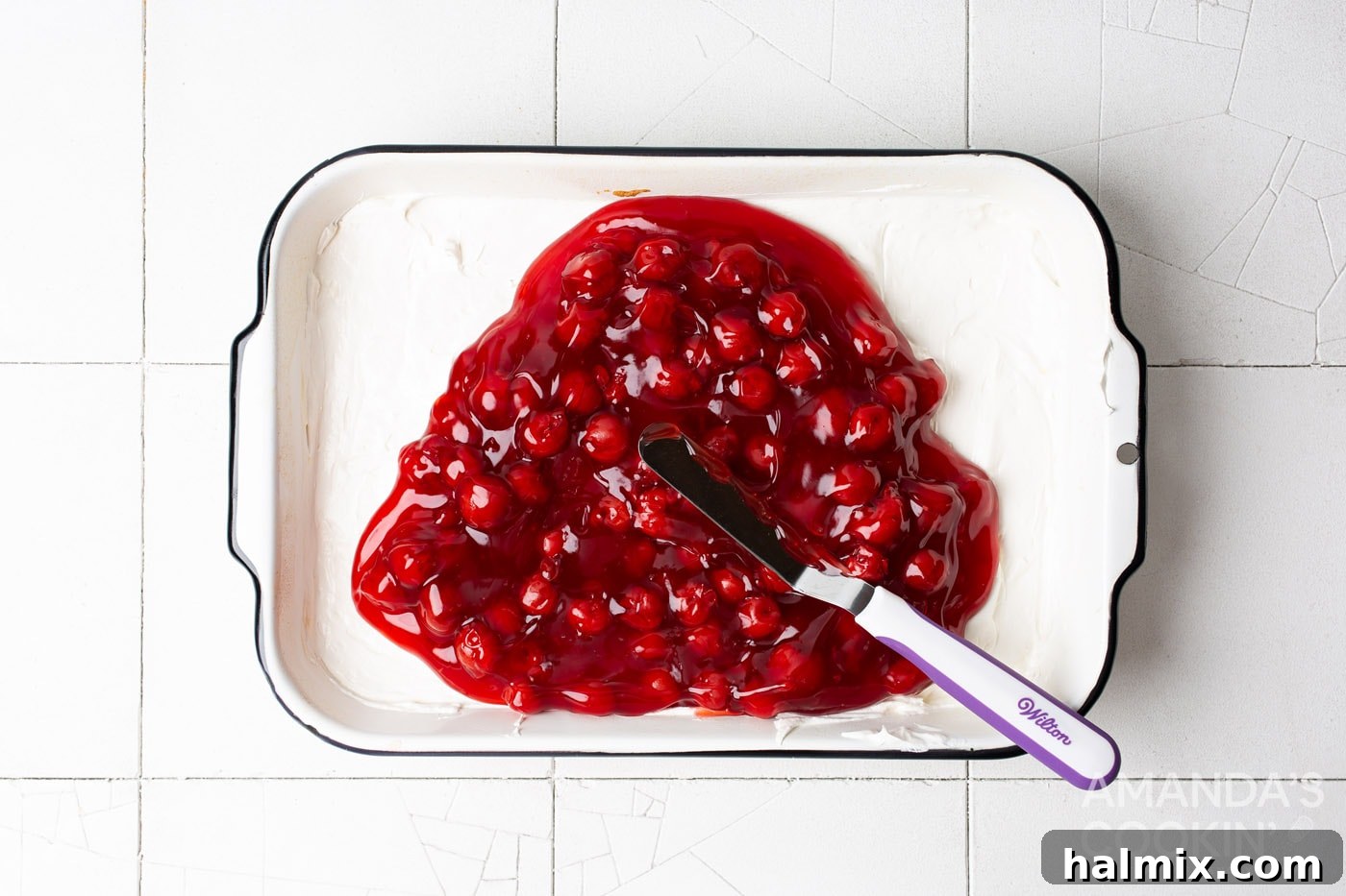 Cherry Velvet 7 cherry pie filling on top of cream cheese mixture in baking pan