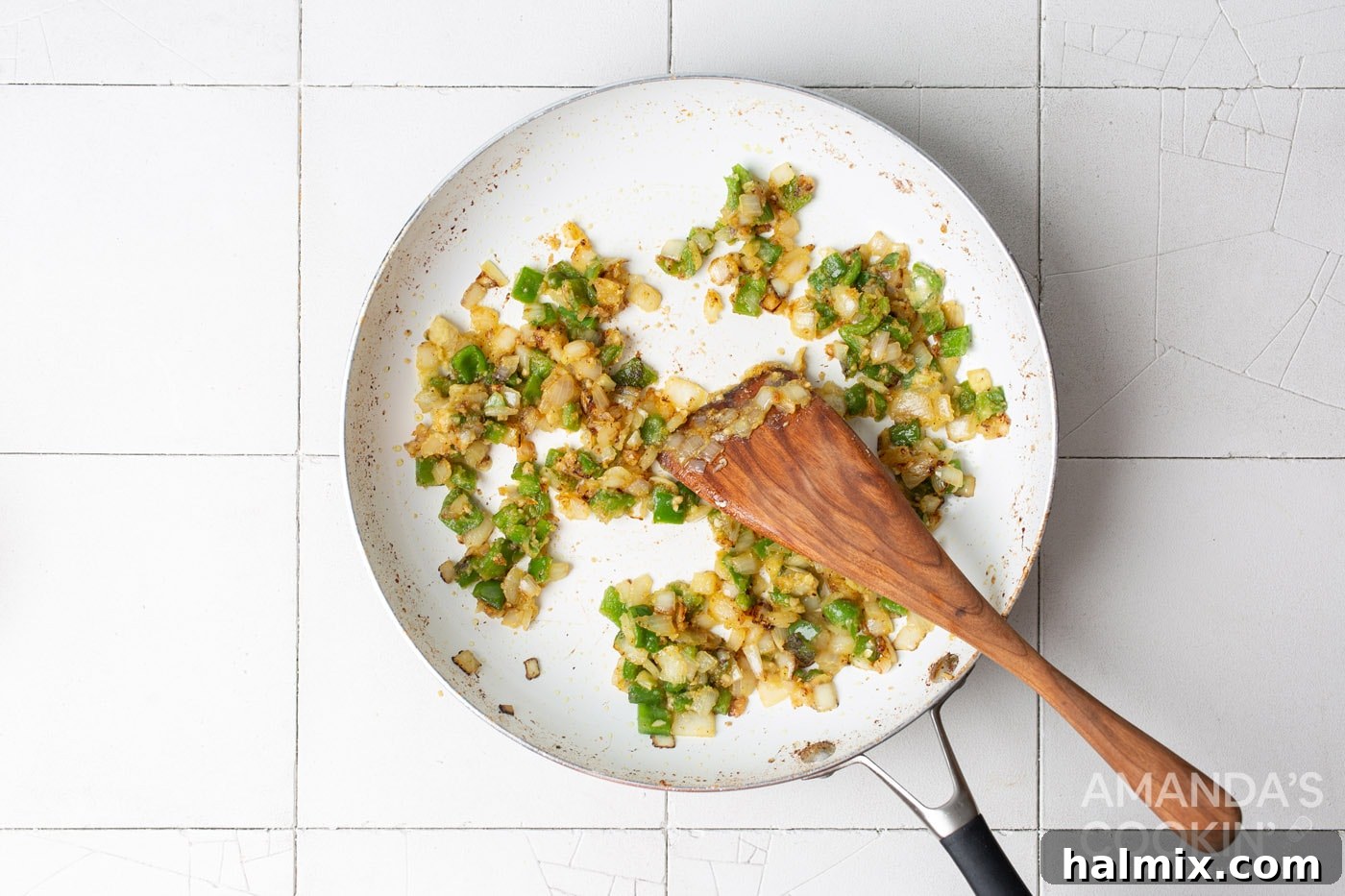 garlic, onion, and pepper sauteeing in a skillet, coated with flour for the roux