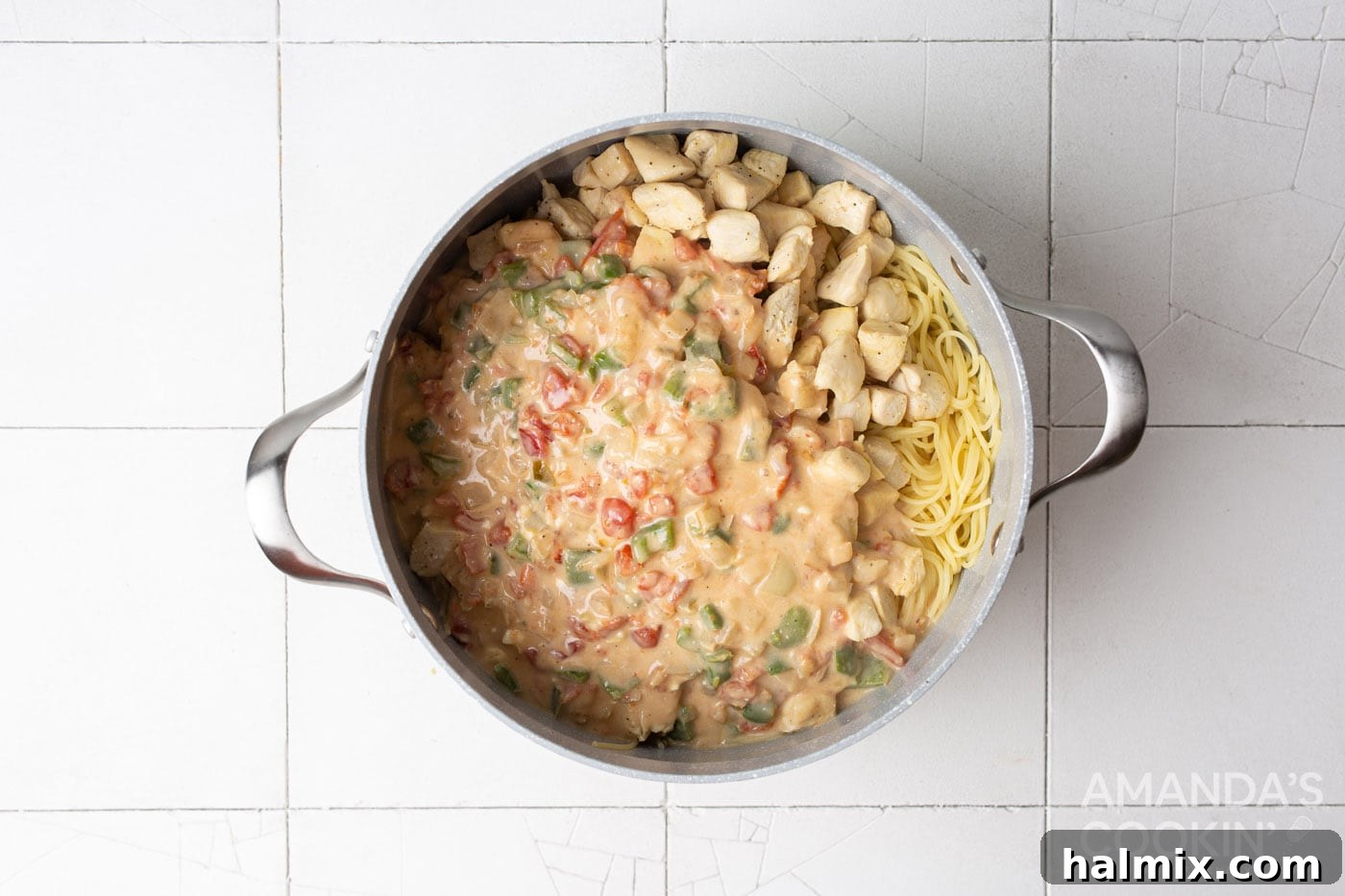 chicken spaghetti mixture in a large pot, ready to be transferred to a baking dish