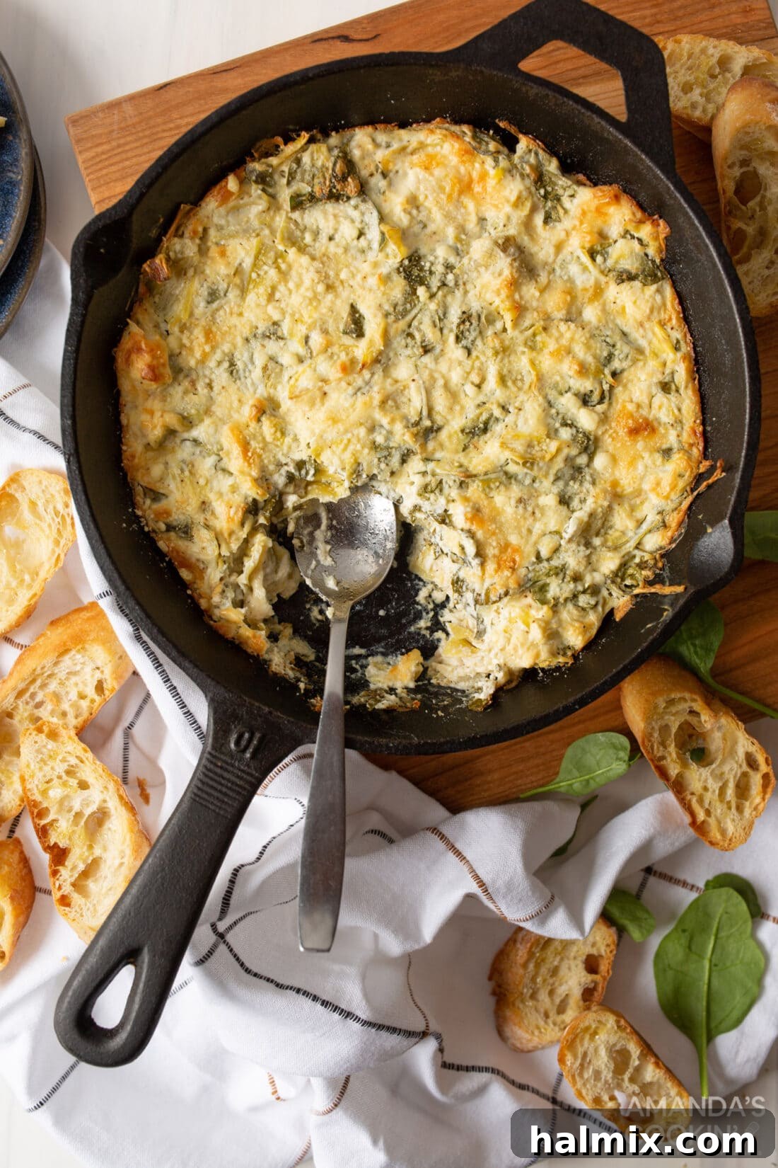 Irresistible Spinach Artichoke Dip 2 cast iron pan of Spinach Artichoke Dip