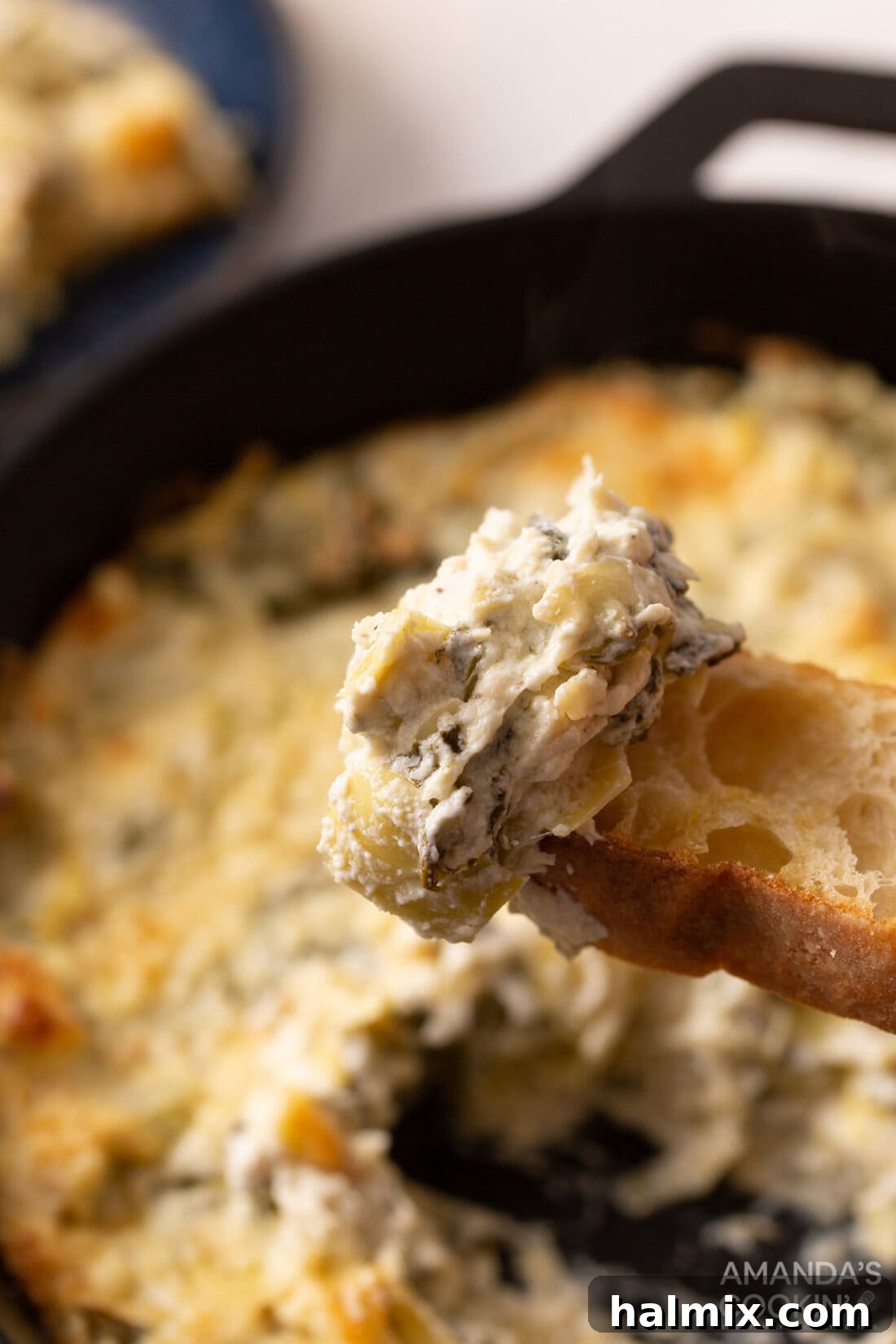 Irresistible Spinach Artichoke Dip 3 Spinach Artichoke Dip on a piece of bread