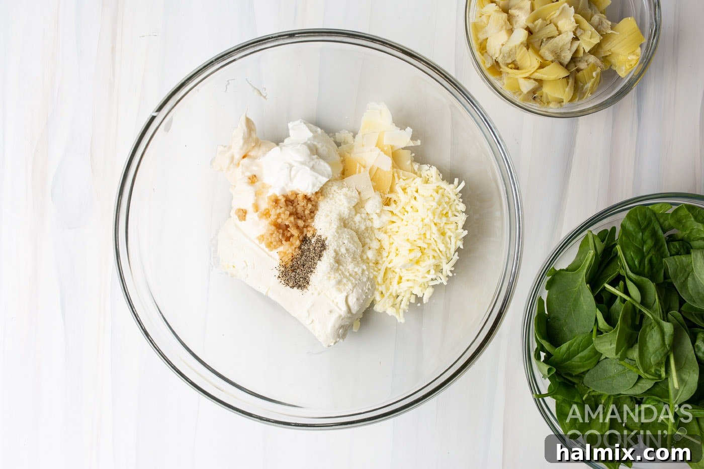 spinach artichoke dip ingredients in a mixing bowl