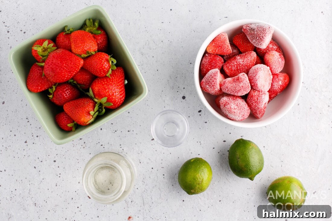 Vibrant Strawberry Daiquiri 4 A collection of ingredients for making a Strawberry Daiquiri, including fresh and frozen strawberries, white rum, lime juice, and simple syrup.