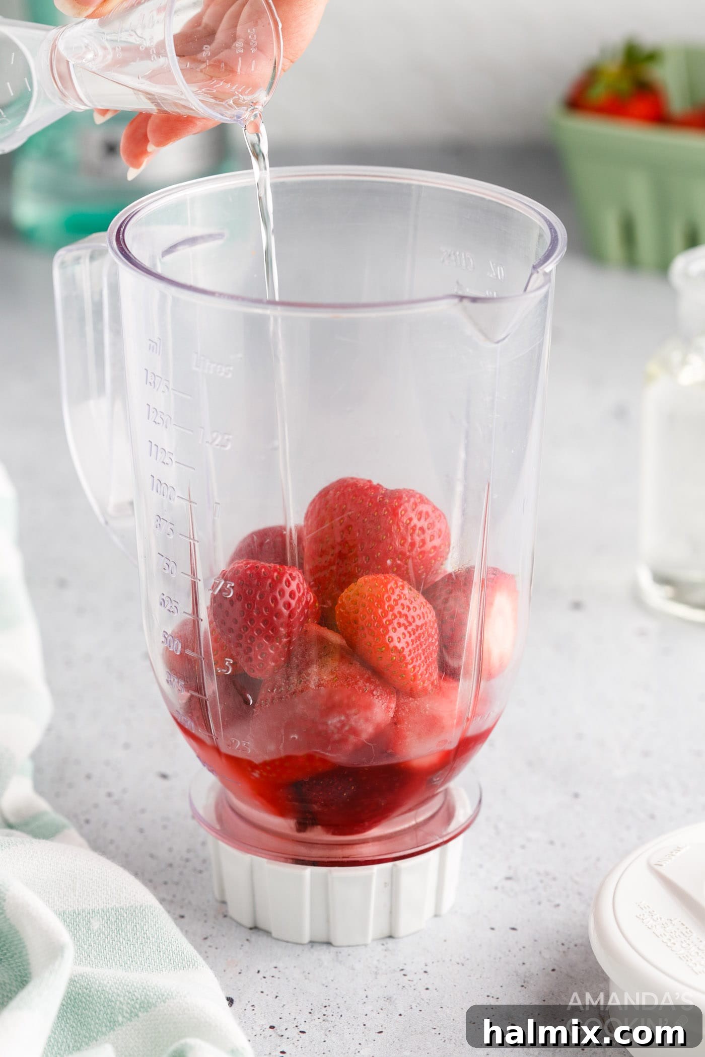 Vibrant Strawberry Daiquiri 5 Pouring simple syrup into a blender with frozen strawberries and other daiquiri ingredients.