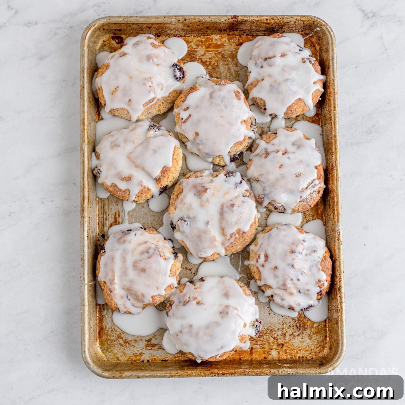 Divine Blackberry Scones 12 glazed blackberry scones on baking sheet after cooling