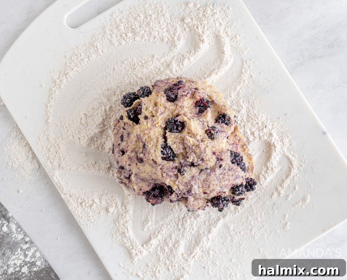 Divine Blackberry Scones 9 blackberry scone dough on floured cutting board, shaped into a disc