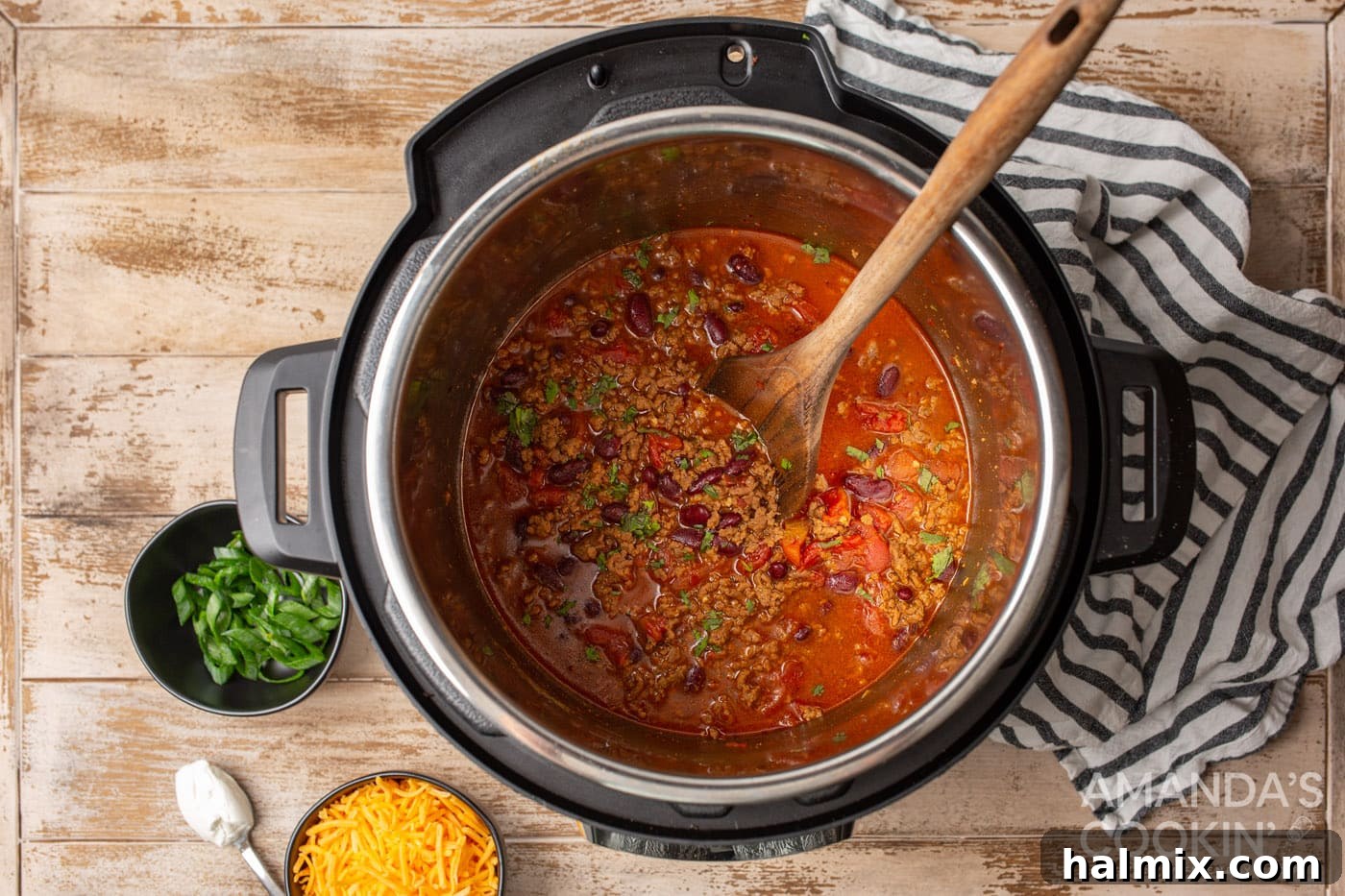chili in the instant pot with wooden spoon