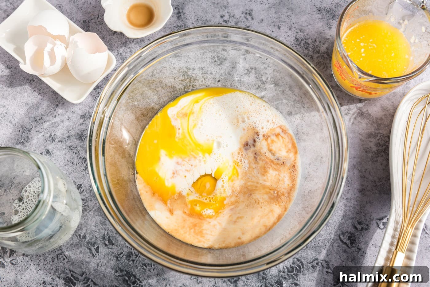 Golden Sugar Plum Muffins 6 A bowl with eggs, vanilla extract, milk, and melted butter, ready to be whisked.