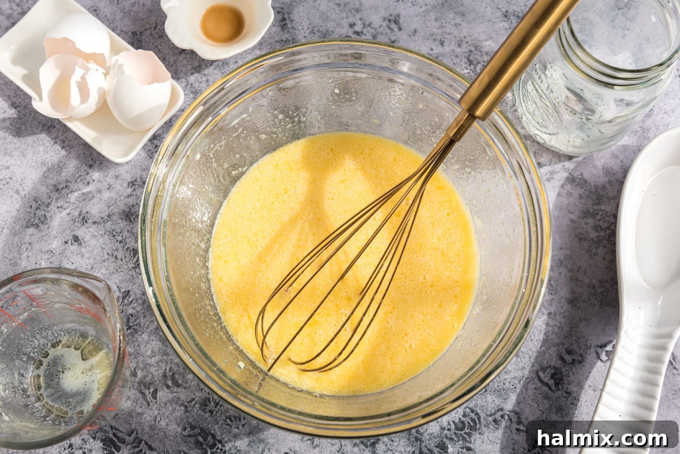 Golden Sugar Plum Muffins 8 The fully whisked egg and milk mixture in a bowl, showing a smooth, consistent liquid for the muffins.