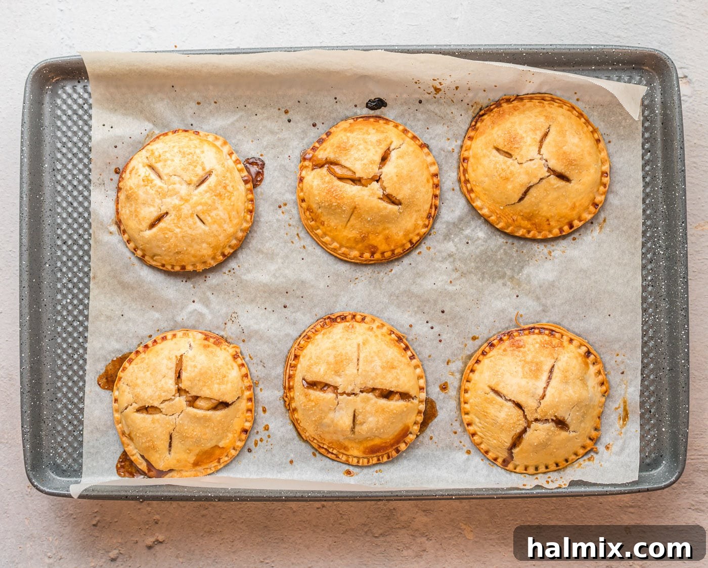 Freshly baked apple hand pies, golden and delicious, just removed from the oven.